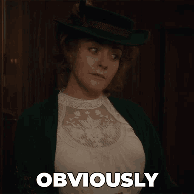 a woman wearing a green hat and a white top is standing in front of a sign that says obviously