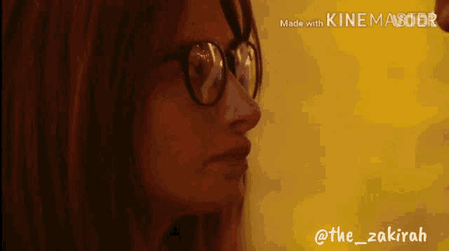 a woman wearing glasses is shown in a video made with kinemaster