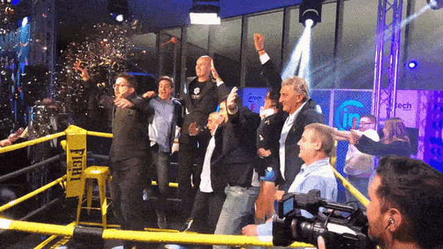 people in a boxing ring with a sign that says fight on it