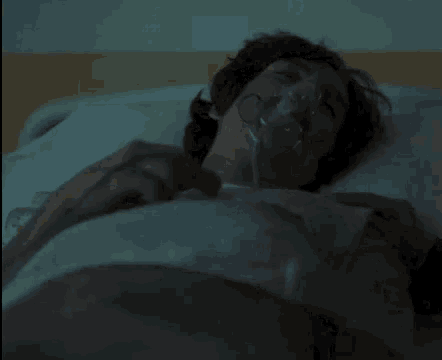 a man with a mustache is laying in a hospital bed .
