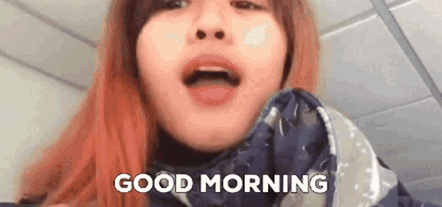 a close up of a woman 's face with the words `` good morning '' written on the bottom .