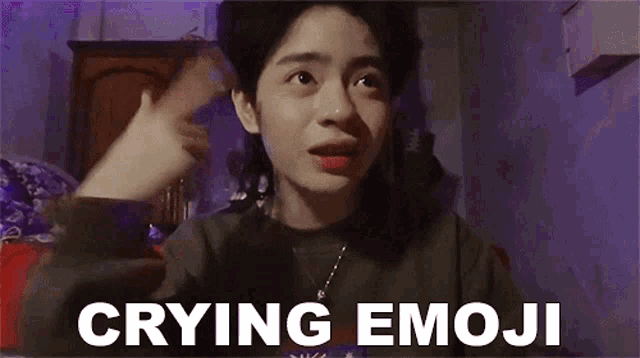 a woman is crying and making a funny face with the words `` crying emoji '' written above her .