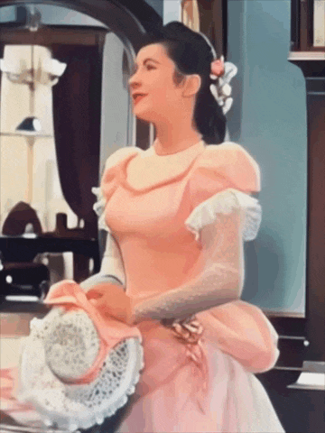 a woman in a pink dress and white gloves is holding a hat