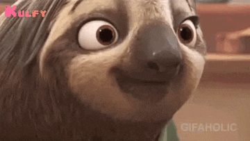 a close up of a cartoon sloth making a funny face and smiling .
