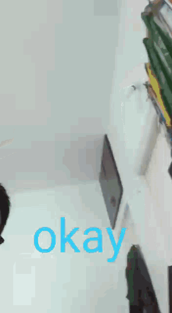 a blurry picture of a man with the word okay in blue letters