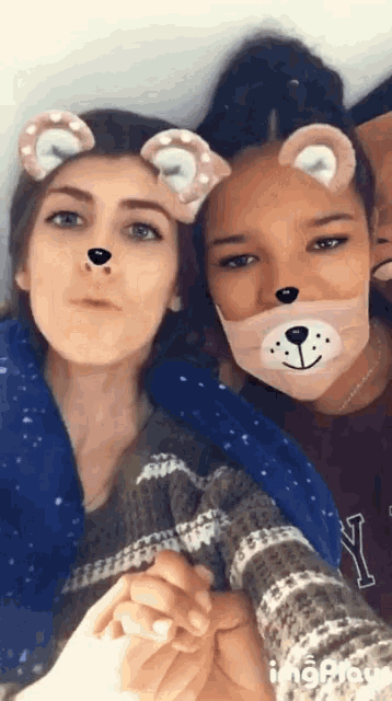 two girls wearing teddy bear face masks pose for a photo