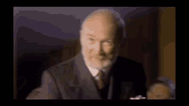 a blurry picture of two men 's faces in a dark room .