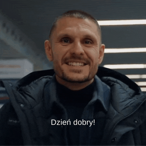 a man with a beard is smiling with the words dzien dobry written below him