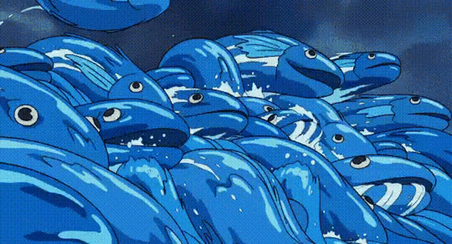 a group of blue fish are swimming in the ocean .