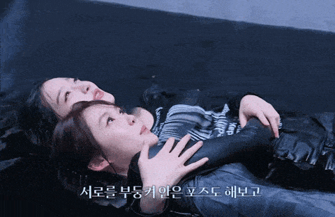 two women laying in the water with korean writing on the bottom of the image
