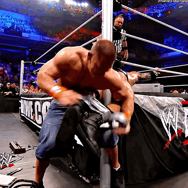 a man in a wrestling ring with the word wwe on the side