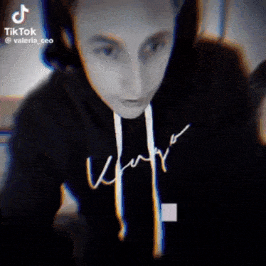 a tiktok video of a person wearing a black sweatshirt