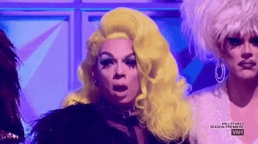 a drag queen with a surprised look on her face .
