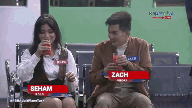 a man and a woman sitting next to each other with seham and zach written on their name tags