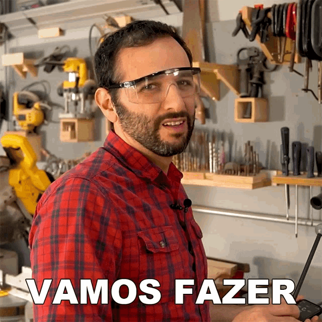 a man in a plaid shirt is wearing safety goggles and says vamos fazer