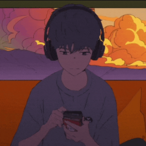 a boy wearing headphones is holding a cell phone