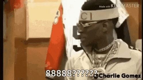 a man wearing a gucci headband and sunglasses is standing in a room .