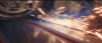 a close up of a person grinding a piece of metal