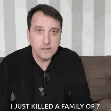 a man in a black shirt is sitting on a couch and says i just killed a family of 7 .