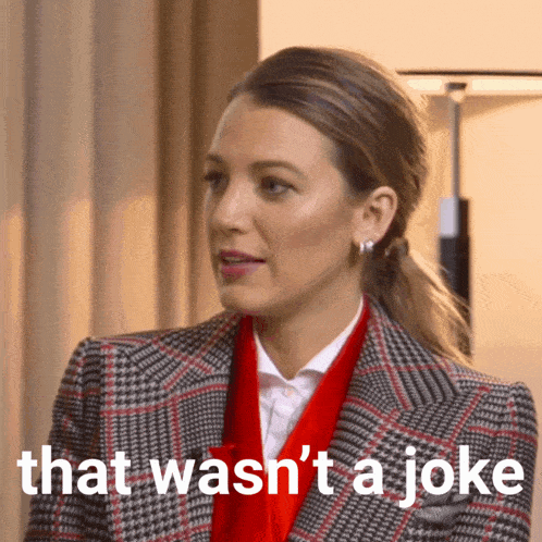 a woman wearing a plaid jacket and red scarf says that wasn 't a joke