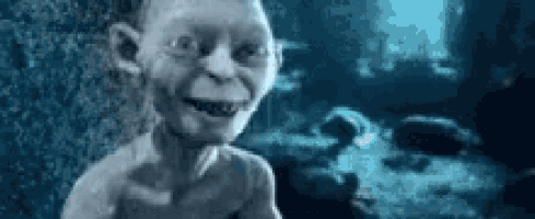 a gollum from the lord of the rings is smiling in a blurry photo .