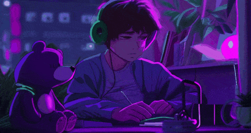 a man wearing headphones is sitting at a desk with a teddy bear .