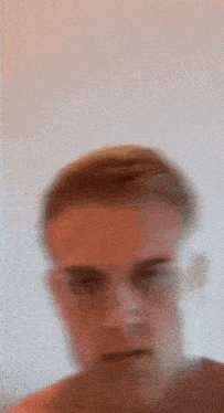a blurry picture of a man 's face with a white background