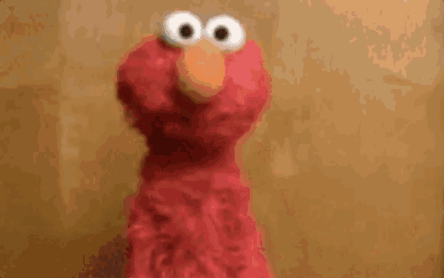 elmo from sesame street is talking in a foreign language .
