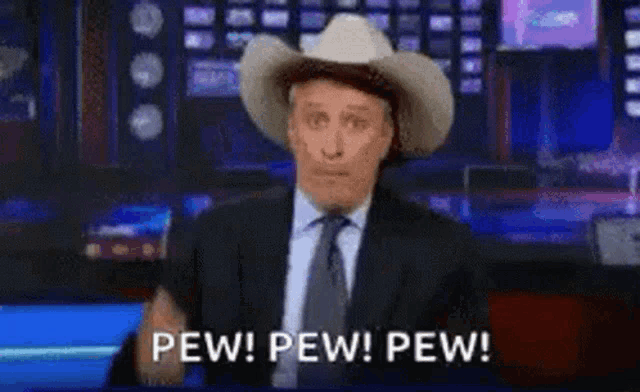 a man in a suit and tie wearing a cowboy hat says pew pew pew .