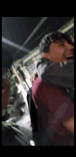 a blurry picture of a man holding another man 's shoulder