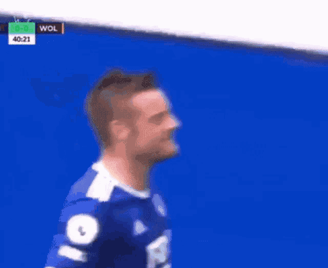 a soccer player in a blue jersey is celebrating a goal during a soccer match .