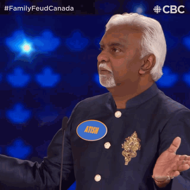 a man with a name tag that says atish