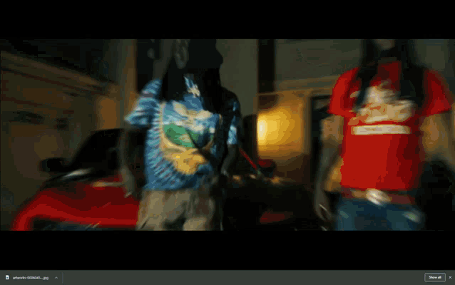 a blurred image of a man pointing a gun with the word share at the bottom right
