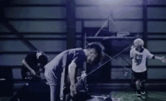 a group of men are playing a game of soccer in a dark room .