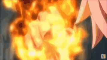 a close up of a person 's fist in front of a fire explosion .