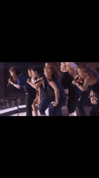 a group of dancers are performing on a stage