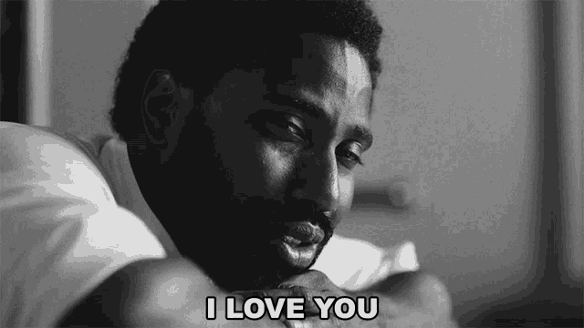 a black and white photo of a man laying down with the words i love you above him