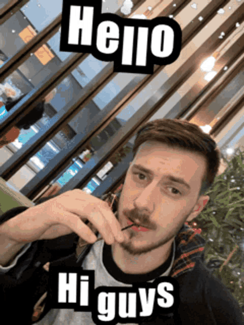 a man smoking a cigarette with a hello hi guys sticker on his face