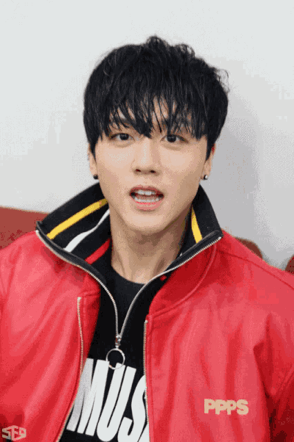 a man wearing a red jacket that says ppps on it