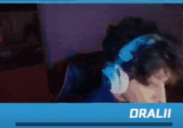 a man wearing headphones is sitting in front of a computer screen .