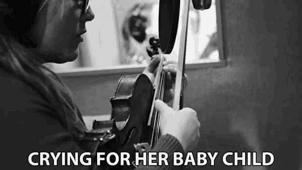 Crying For Her Baby Child Strumming GIF - Crying For Her Baby Child Strumming Singing GIFs