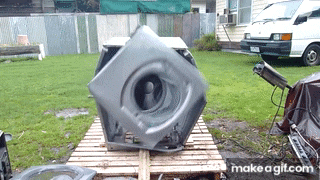 a large gray object is sitting on a wooden pallet with makeagif.com in the corner