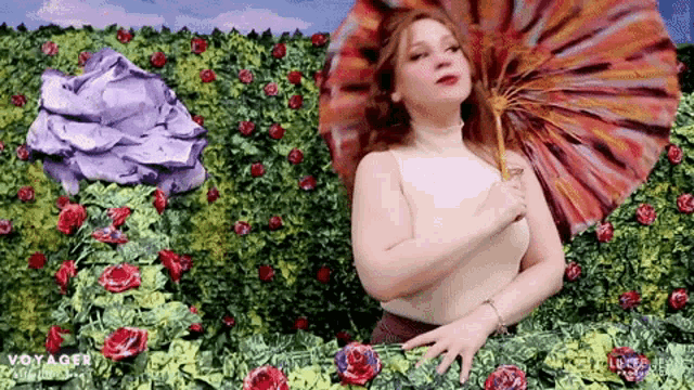 a woman holding an umbrella in front of a wall of flowers with the word voyager on the bottom