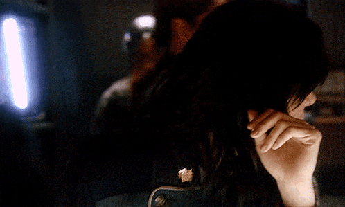 a close up of a woman 's face in a dark room .