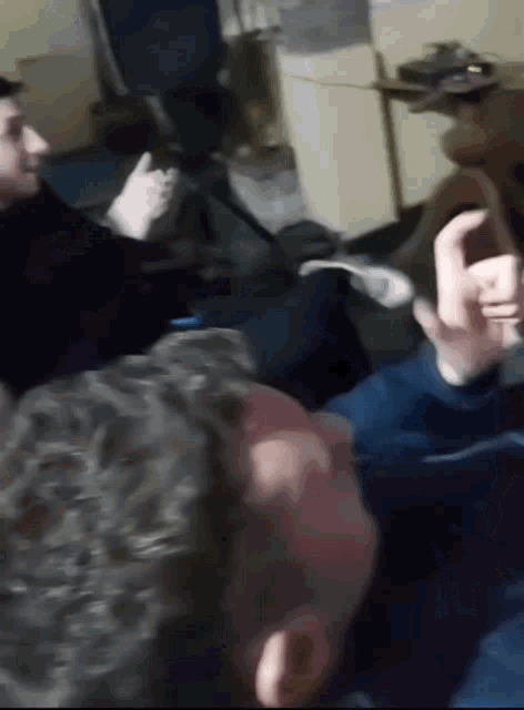 a man is giving a thumbs up in a room