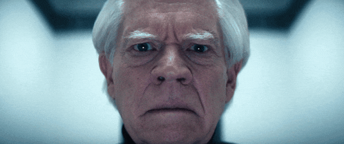 a close up of a man 's face with gray hair