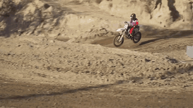 a person is riding a dirt bike with the number 72 on it