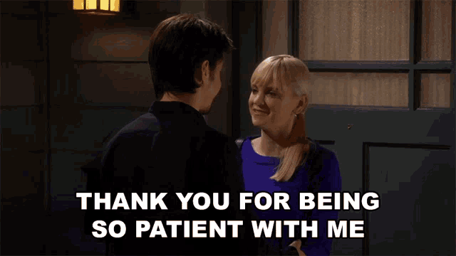 a man and a woman are standing in front of a door and the woman says thank you for being so patient with me