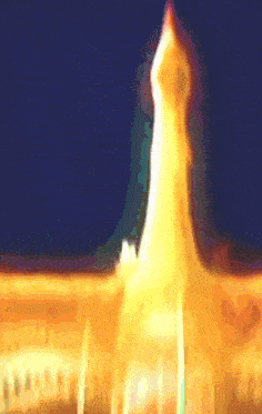 a blurry picture of a tower with a blue sky behind it