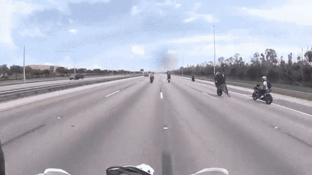 a group of people on motorcycles are riding down a highway